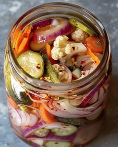 a jar filled with lots of different types of vegetables