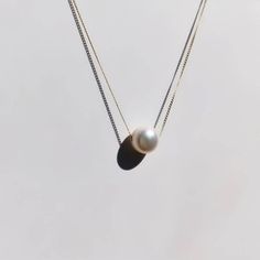 A beautiful, dainty floating pearl necklace made of 9ct yellow gold. The pearl is a genuine cultured freshwater pearl. It is 8mm in diameter and has been hand drilled to float on a 0.75mm delicate 9ct gold chain. Chain length can be chosen from the drop box at checkout. Pearl is the birthstone for June and so this stunning necklace would make the perfect gift for a June baby. Pearl also represents the 30th anniversary of a special bond and can be given as an anniversary present to signify the be Dainty Akoya Pearl Pendant Necklace, Classic Round Pearl Necklace With Delicate Chain, 14k Gold Pearl Drop Necklace As Gift, 14k Gold Pearl Drop Necklace For Gift, Classic 14k Gold Pear-shaped Necklace, Classic Pear-shaped 14k Gold Necklace, Minimalist 14k Gold Necklace With Pearl Pendant, Minimalist Pear-shaped Pearl Pendant Necklace, Minimalist White Pearl Necklace With Charm