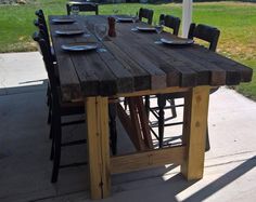 a wooden table sitting on top of a sidewalk