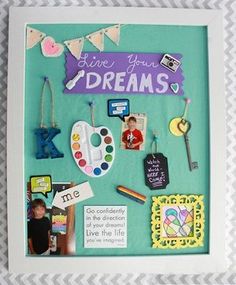 a frame with some pictures and magnets on it that says live your dream dreams