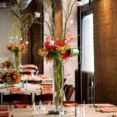 the table is set with flowers and place settings