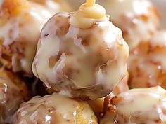 a close up of doughnuts with icing and a candle sticking out of them