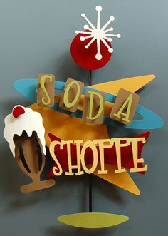 there is a sign that says soda shoppe with an ice cream sundae on it