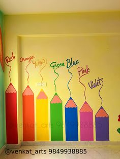 a room with colorful crayons painted on the wall