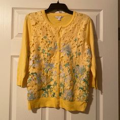 Yellow Cardigan Sweater With Cut Out Floral Design On The Front. Three Quarter Sleeves. Buttons Up The Front. Very Pretty! Size Large. New With Tags. Yellow Long Sleeve Casual Cardigan, Handmade Yellow Winter Cardigan, Burgandy Sweater, Yellow Buttoned Cardigan, Yellow Fitted V-neck Cardigan, Jeweled Sweater, Teal Cardigan, Silver Sweater, Red Cardigan Sweater