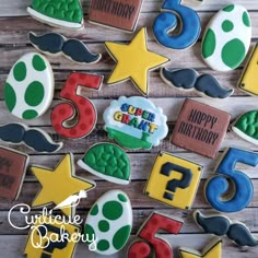 decorated cookies with numbers and mustaches on a wooden table in the shape of stars