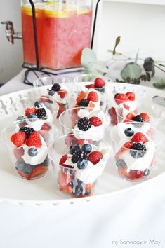 small cups filled with fruit on top of a white plate