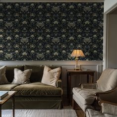 a living room with two couches and a table in front of the wallpaper