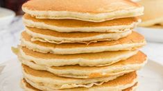 a stack of pancakes sitting on top of a white plate