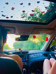 two people sitting in the driver's seat of a car