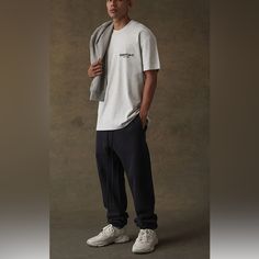 The Essentials Fear Of God Stretch Limo Sweatpants Feature A Relaxed Fit, Rubber "Essentials" Branding On The Front, Logo Graphic On The Leg, And Elastic Bands At The Waist And Cuffs. Solid Color Sweatpants Rubber Brand Label Side And Back Pockets Elastic Waistband And Cuffs Long Drawstrings Logo Brand Graphic On Leg Relaxed Fit Inseam: 31" Front Rise: 12” Back Rise: 13” Length: 42” Waist Laying Flat 15.5” Hips Laying Flat 21.5” 80% Cotton, 20% Polyester Classic Sweatpants With Relaxed Fit And Straight Hem, Classic Relaxed Fit Sweatpants With Straight Hem, Classic Pants With Straight Hem For Loungewear, Classic Straight Hem Pants For Loungewear, Everyday Athleisure Bottoms With Straight Hem, Classic Relaxed Fit Sweatpants, Classic Cotton Sweatpants With Straight Hem, Straight Leg Relaxed Fit Sweatpants For Elevated Casual, Relaxed Fit Everyday Joggers With Straight Hem