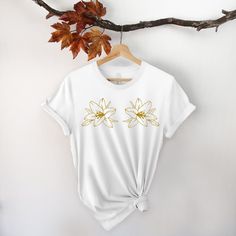 "Magnolia Shirt, Magnolia, Magnolia Tee, Mognalias Shirt, Floral Shirt, Flower Shirt, Plant Shirt, Gift for Plant Lovers, Trend Welcome to my store :) I am so glad to see you here. I make my t-shirts with love. I am sure you will like them. Please make sure you check the size chart before ordering. Unisex size is fit for men but a little loose for women. If you want to have a fitter look, you can select one size smaller. The inscriptions on the T-shirts are black in light colors and white in dar White Floral Embroidery Relaxed Fit Top, White Floral Embroidered Relaxed Top, White Floral Embroidered Relaxed Fit Top, White Short Sleeve T-shirt With Floral Embroidery, Spring White Print Graphic Tee Shirt, Yellow Cotton Shirt With Sublimation Print, White Floral Embroidery Short Sleeve T-shirt, White Floral Embroidered T-shirt, White Floral Embroidered Short Sleeve T-shirt