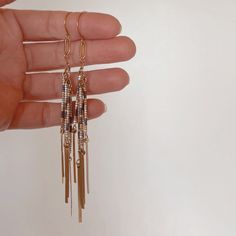 BEADED FRINGE EARRINGS |FEATURES|: -earrings measure 4" (at longest fringe) -11/0 delica beads in ivory, olive drab + gold -gold plated link detail -brass hook |CARE INSTRUCTIONS|: Brass oxidizes over time, giving it a vintage look. Oxidation can be removed with a soft cloth, if desired. Exposure to water can expedite the oxidation process.  |PRODUCTION TIME|: Usually within 3-5 business days (excluding weekends + holidays). Please message for any rush orders. |SHIPPING TIMES (transit times once your order has shipped US orders ship USPS First Class Mail, 3-5 business days. Gold Fringe Earrings In Brass, Adjustable Gold Bohemian Tassel Earrings, Gold Metal Fringe Tassel Earrings, Gold Metal Tassel Earrings With Fringe, Bohemian Brass Fringe Earrings, Elegant Tassel Earrings In Brass, Bohemian Brass Jewelry With Fringe, Bohemian Brass Fringe Jewelry, Metal Tassel Fringe Drop Earrings