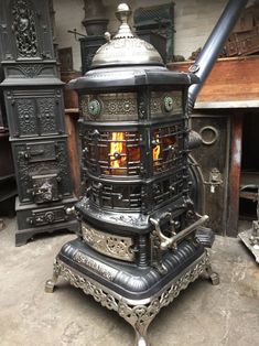 an old fashioned stove sitting on top of a floor