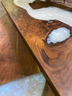 a wooden table with white foam on it and some wood in the middle that is shaped like a tree trunk