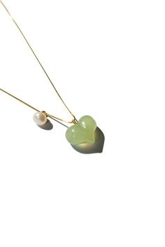 Necklace      nephrite    the puffed heart necklace features a green jade heart pendant puffed to perfection complemented by a delicate pearl. the unique puffed design of the jade heart adds a playful touch making it an irresistibly cute accessory.    length: 17.5"  weight: 20g  heart pendant: 10mm x 13mm x 5mm  material: nephrite pearl gold-plated sterling silver    [#other]    product care    avoid knocking against hard surfaces. jade pieces are brittle and will break when hit with hard objects. make sure that you take off your jewelry before you go swimming in a pool or hot tub. if you’re handling dirt and soil quartz dust in soil is abrasive to the stone. avoid cleaning your jade with any acids or alcohol! it is suggested to only apply water or water mixed with mild soap to get it nice Puffed Heart Necklace, Go Swimming, Water Mixes, Puffed Heart, Jade Necklace, Pearl Pendant Necklace, Green Necklace, Green Jade, Jade Green