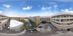 an aerial view of a parking lot with several cars parked in front of the building