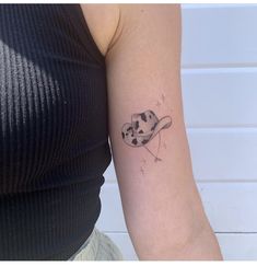 a woman with a tattoo on her arm that has an image of the moon and saturn