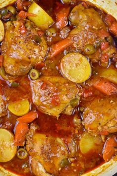 a pot filled with stew and vegetables on top of a table