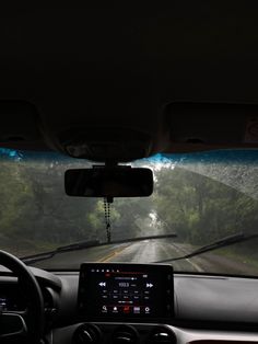 the dashboard of a car with trees in the background