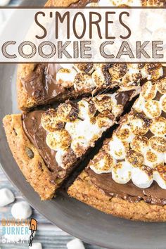 a chocolate cookie cake with marshmallows and s'mores on top