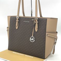 Brand New With Tag 100% Authentic Color: Camel Michael Kors Gilly Large Drawstring Travel Tote -11.5”H X 6.5”W X 14”L -Gold Tone Hardware -Top Zip Closure -Mk Signature Pvc And Saffiano Leather -Interior: 2 Slip And 1 Zip Pocket -Exterior: 2 Side Slip Pockets Michael Kors Brown Coated Canvas Bag, Michael Kors Brown Shoulder Bag For Travel, Michael Kors Brown Everyday Shoulder Bag, Michael Kors Beige Leather Bag, Michael Kors Beige Leather Shoulder Bag, Michael Kors Brown Shoulder Bag For Shopping, Modern Beige Michael Kors Shoulder Bag, Beige Shoulder Bag With Branded Hardware For Travel, Modern Beige Michael Kors Bag