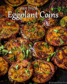 fried eggplant coins in a pan with herbs