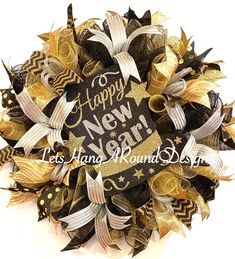 a happy new year wreath with gold and black decorations