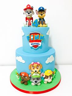 a blue cake with cartoon characters on it