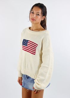 We are loving this American Flag Sweater. Featuring a bold flag design, this cozy sweater is perfect for the fall weather. The soft knit fabric and relaxed fit make it great for layering or wearing on its own. Pair it with denim shorts or jeans for a timeless, casual look. The Details Stitched American Flag on Front Ribbed Hem and Cuffs Rounded Neckline 100% Acrylic [#other] Wash With Like Colors Machine Wash Cold Do Not Bleach [/other] Going Out Skirts, Flag Sweater, American Flag Sweater, Pumpkin Patch Outfit, Mini Skirt Dress, Sweat Joggers, Sweater Cream, Flare Leg Jeans, Thanksgiving Outfit