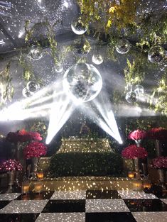 an elaborately decorated stage with lights and chandeliers in the middle of it