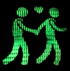 two people are dancing in the dark with green lights on them, and they appear to be holding each other's hands