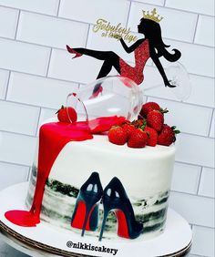 a birthday cake decorated with high heel shoes and a woman's silhouette on top