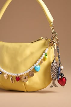 Charming new-trend alert: jewelry for your bag, featuring an antique-inspired brass fish. | Antique Fish Bag Charm by Anthropologie in Gold, Women's, Brass Aesthic Things To Buy, Purse Chain Charm, Purse Chain Accessories, Bag Chain Charm, Purse Charms Aesthetic, Purse Accessories Ideas, 2025 Jewelry Trends