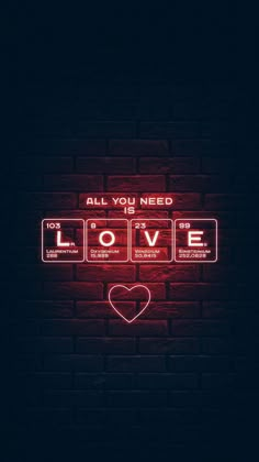 all you need is love neon sign on brick wall