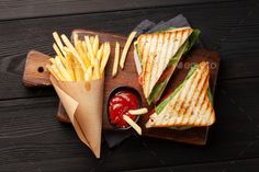 sandwich with fries and ketchup on wooden tray - stock photo - images in gallery