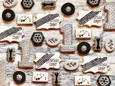 decorated cookies are arranged in the shape of letters and numbers on a marble table top