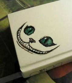 a white box with a green face painted on it