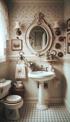 a white sink sitting under a mirror in a bathroom next to a toilet and window