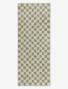 a green and white rug with squares on it