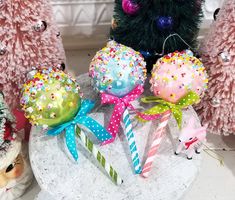 there are many christmas decorations on the table together, including balls and candy canes