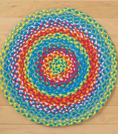 a multicolored round rug on a wooden floor