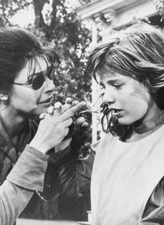 two women are eating something out of their mouths