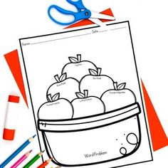 a coloring page with apples in a bowl on top of colored pencils and crayons