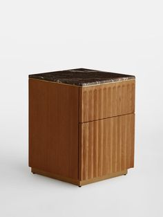 a wooden box with a marble top on it's side, against a white background