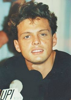 a man sitting in front of a microphone