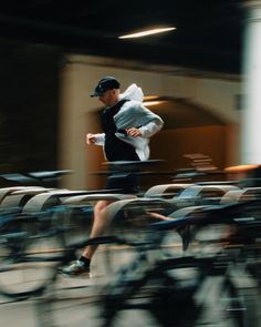 a man running in front of some bikes