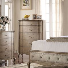 a bedroom scene with focus on the bed and dresser