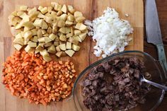 chopped up vegetables and diced meat on a cutting board