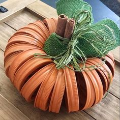 an orange pumpkin sitting on top of a wooden table